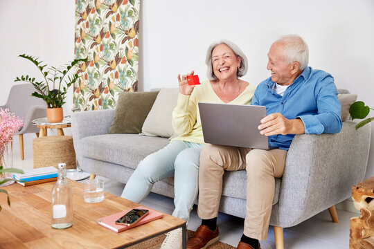 Senior couple laughing during online shopping