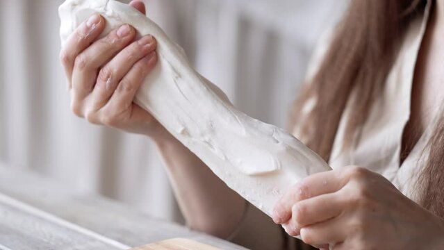 Handcraft woman master modeling cold porcelain, hands pull the clay dough in different directions, Girl sculpts from porcelain, hobby for the soul scandinavian and boho style interior decor