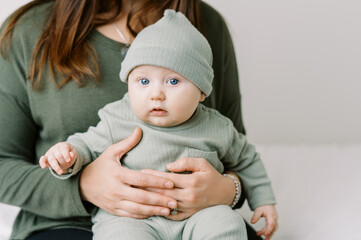 Mother holding her baby in her arms indoors