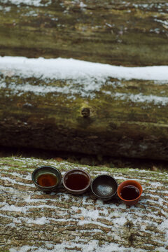 Tea bowls with hot tea on the big fallen tree