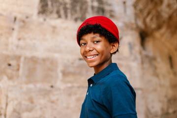 Happy black youth in beanie