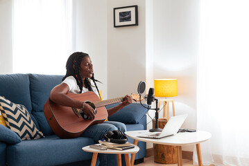 Old black lady Playing Guitar At Home 