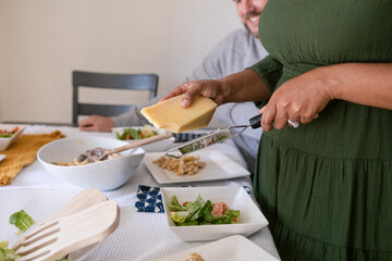 Crop woman shredder parmesan cheese