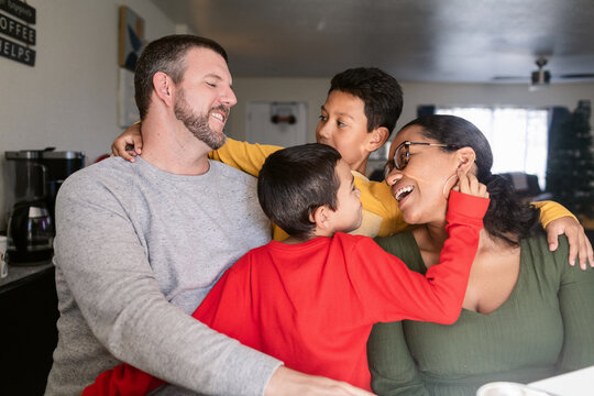 Multiracial Family hugging together at home