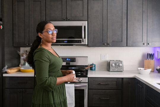 Mixed race woman wearing glasses in her kitchen