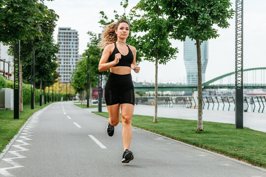 Woman Running On Urban Track.