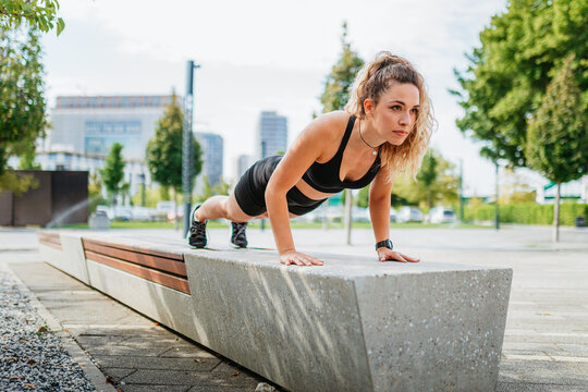 Woman Doing Push Ups On Bench. 