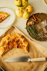 autumn still life with apple almond frangipane galette on brown parchment paper	