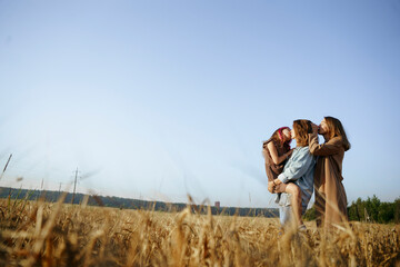 LGBT family with a daughter in wheat field