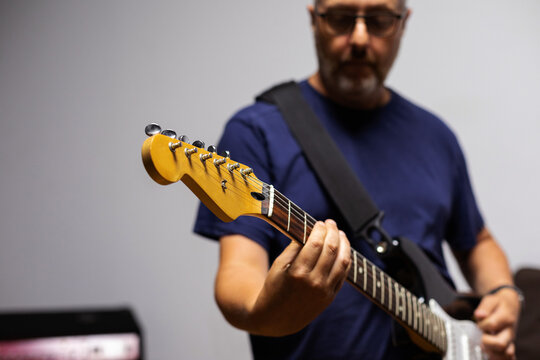 Man Playing Guitar In Studio