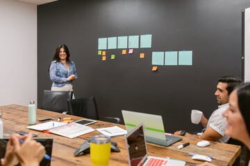 Woman leading happy team meeting