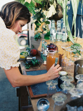 Woman Writing Down Bar Menu At Garden Party Set Up