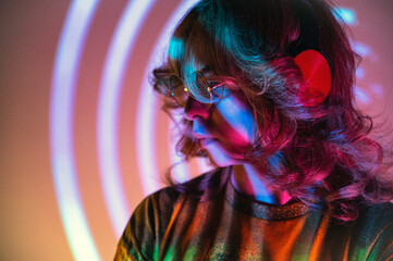 Non binary person with headphones