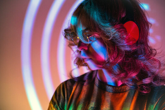 Non binary person with headphones