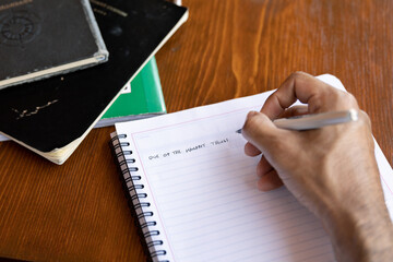 Human hand writing on notebook