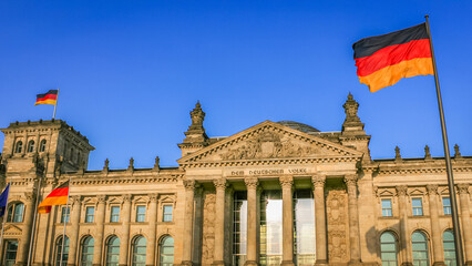 Obraz premium Reichstag building, seat of the German Parliament with national flag, Berlin
