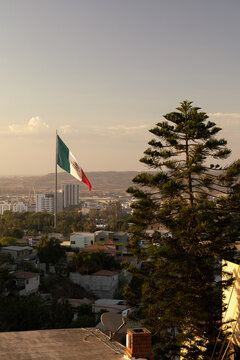 Mexico's Flag in the city of Tijuana overlooking the border 