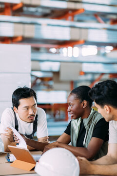 Woman and Two Men Working in Factory 