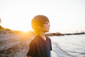 portrait of tween boy at sunset on the beach