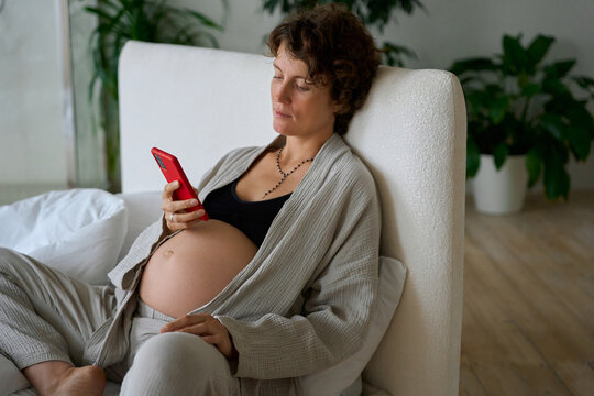 pregnant woman with a phone in her hands