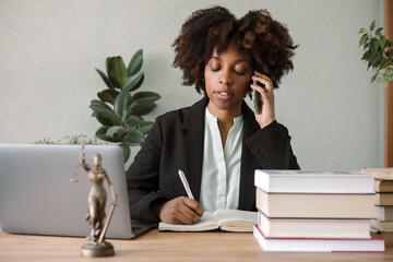 Dark-skinned young woman works in the office 
