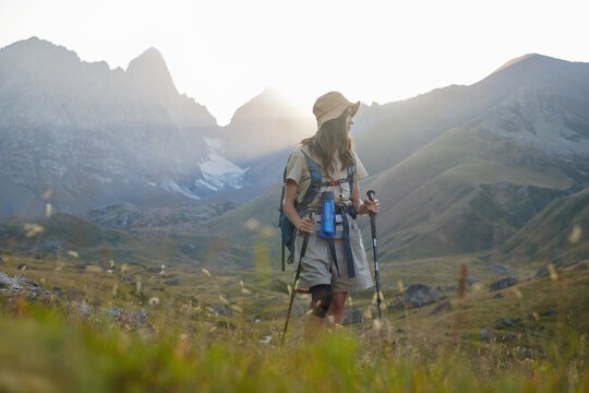 Woman hikes in an alpine mountain area