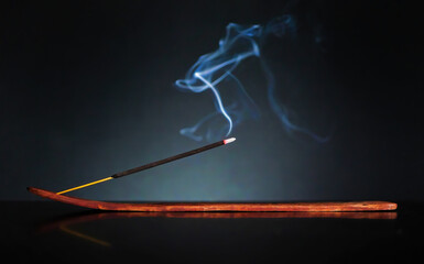White smoke from meditative incense sticks on black background. Pure relaxation theme.