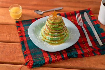 Fun Christmas breakfast for children. Pancakes in the shape of a Christmas pine tree.
