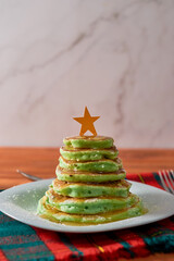 Christmas themed breakfast. Pancakes decorated in the shape of a Christmas tree.