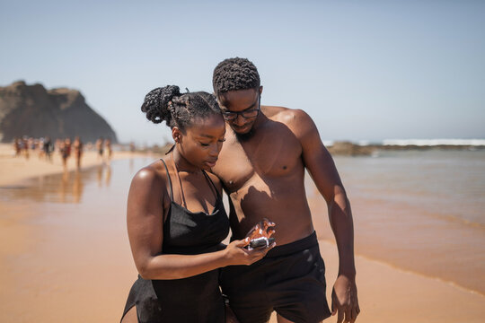 young black couple on the beach by the sea shore