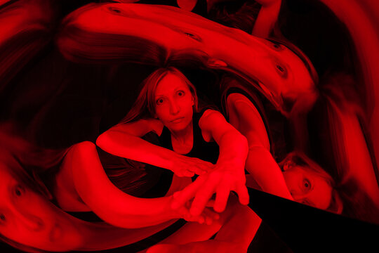 A weird space of distorted reflections in red.