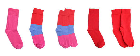 Set with pairs of different color socks on white background, top view. Banner design