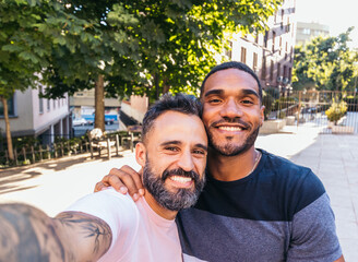 Selfie of a multiracial gay couple outdoors