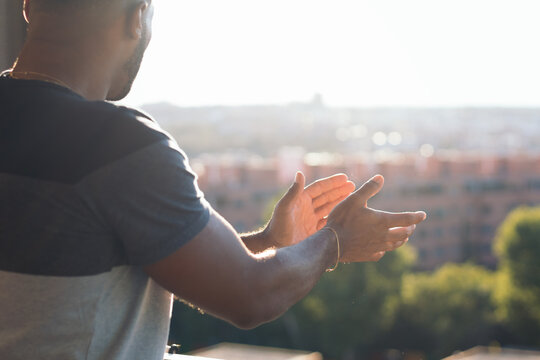 Black Man On Balcony Clapping During The COVID-19 Pandemic