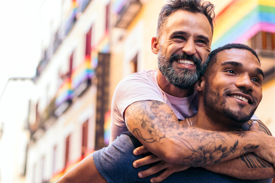 Couple having fun in the street piggyback