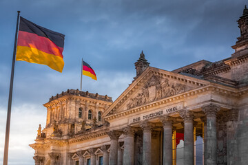 Naklejka premium Reichstag building, seat of the German Parliament with national flag, Berlin