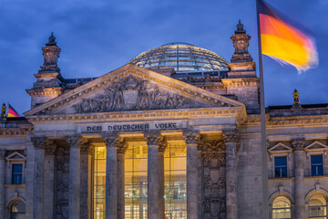 Reichstag building, seat of the German Parliament with national flag, Berlin - obrazy, fototapety, plakaty