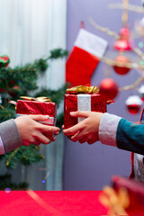 Obraz na płótnie Canvas Excited kids exchanging christmas gifts