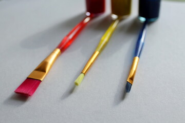Fototapeta premium objects for drawing, paints and brushes in red, yellow, blue on a white background