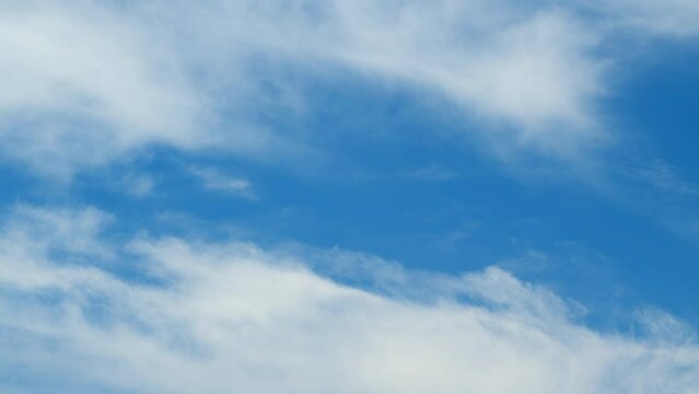 Delicate cirrus clouds in sky in august. Natural background texture taken on sunny day. Time lapse.