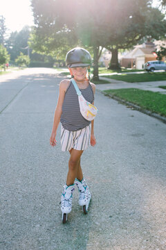girl rollerblades on sunny street