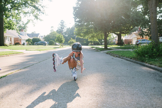 girl rollerblades on sunny street