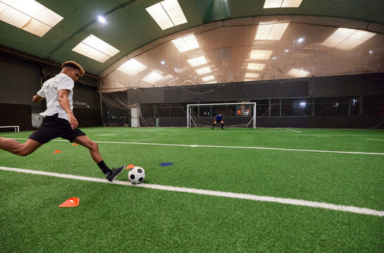 Teen football players playing  ball