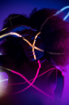 African American model under colorful neon illumination