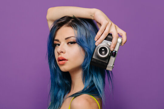 Young alternative woman with retro camera
