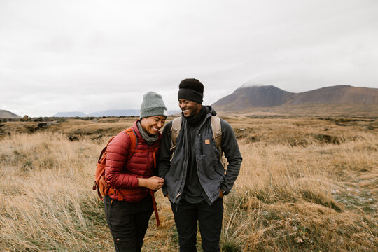 Young couple hiking and laughing