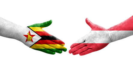 Handshake between Austria and Zimbabwe flags painted on hands, isolated transparent image.