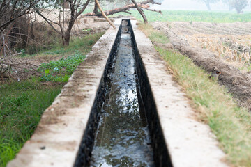Obraz premium Water canal for crop field irrigation system in the village.
