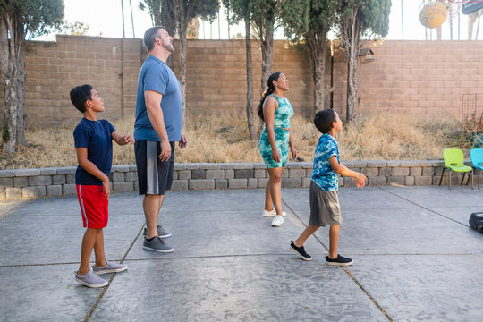 Parents and children playing basketball outdoor