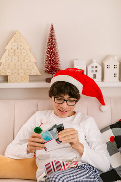Cheerful child opens gifts on Christmas day